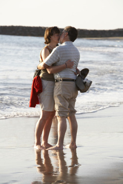 couple kissing on a beach 